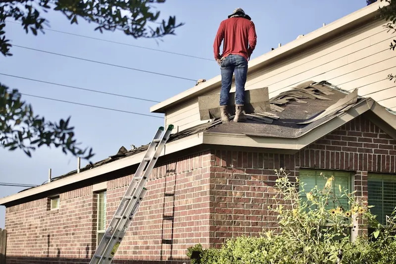 Professional roofer working on a residential roof in Bonaparte Landing